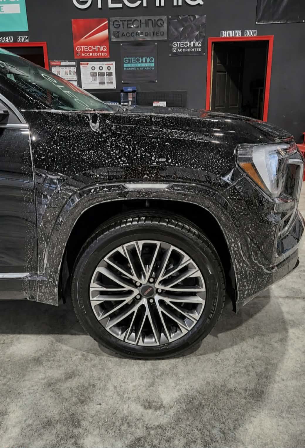 Black GMC Canyon during paint correction wash