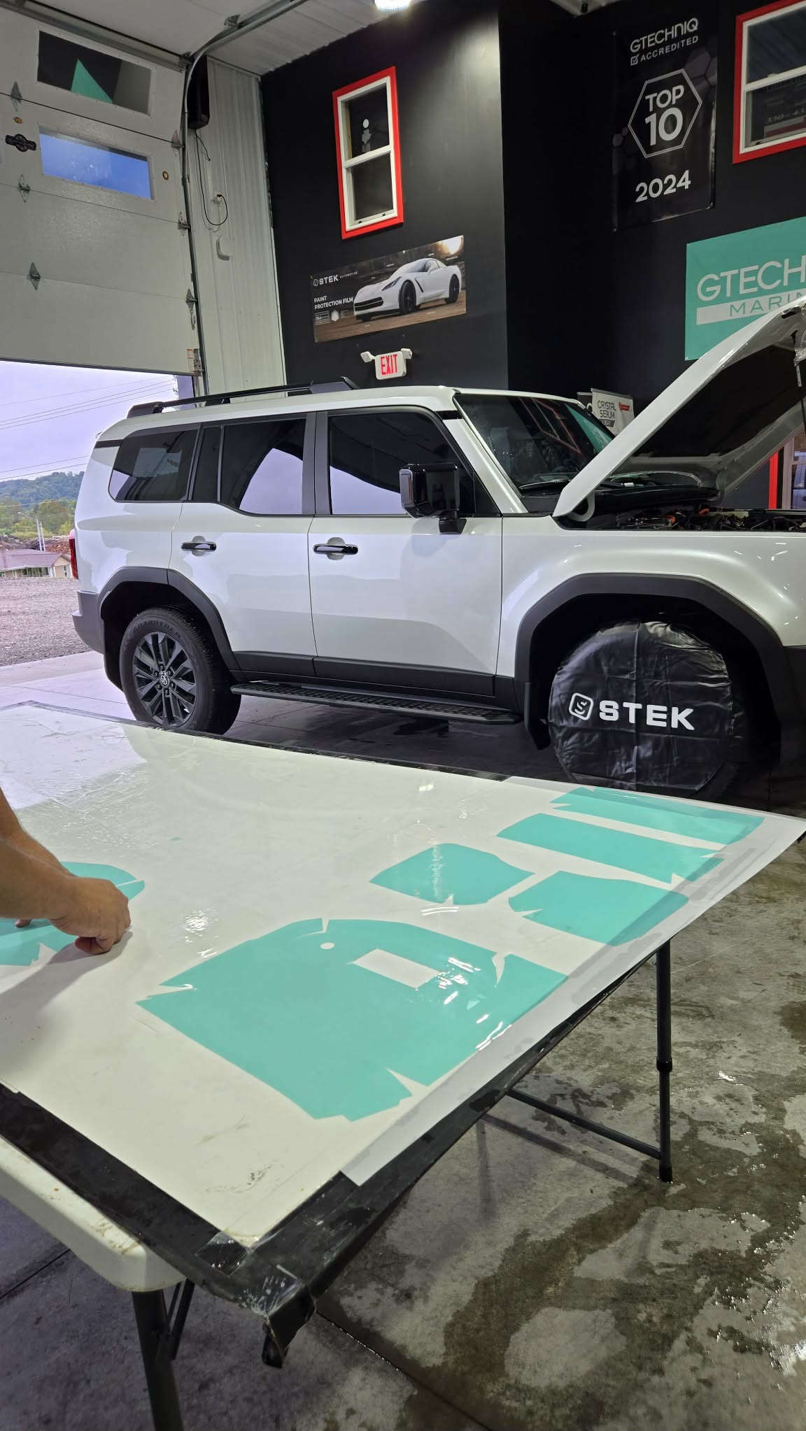 White Land Cruiser with tinted glass in the shop